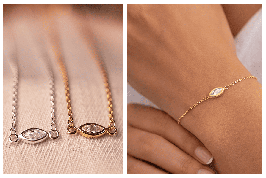 Na tkaninie leżą dwie bransoletki z cyrkonią markiza (srebrna i złota); obok złota bransoletka na nadgarstku