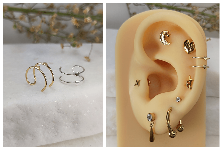 Dwie nausznice z motywem serduszka w kolorze złotym i srebrnym na marmurowym tle oraz ucho z kilkoma kolczykami, w tym nausznicą z serduszkami