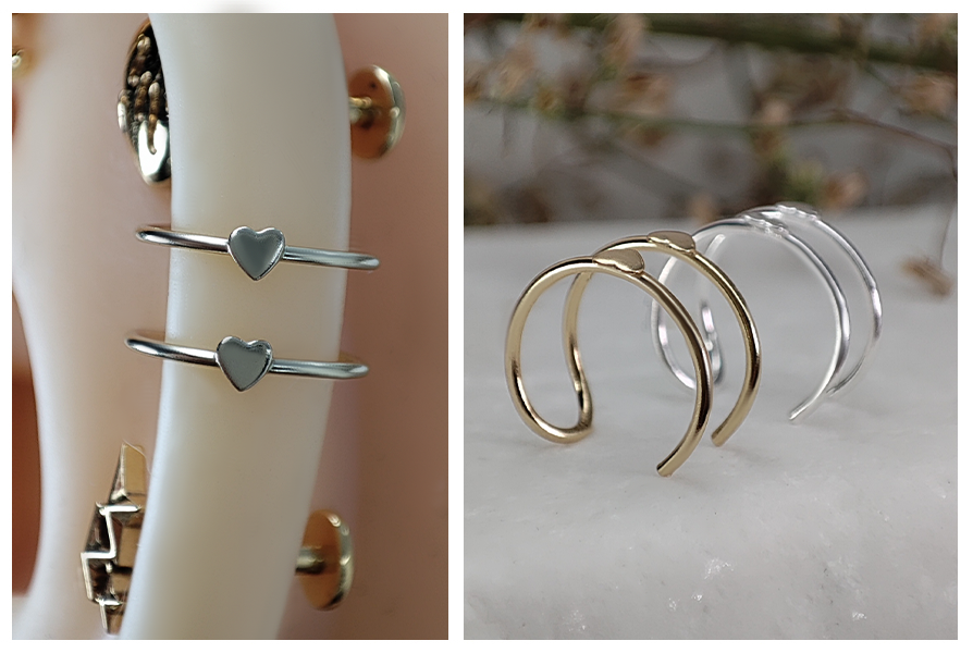 Srebrna nausznica z serduszkiem założona na silikonowym modelu ucha oraz trzy nausznice z sercem w kolorze złotym i srebrnym ustawione obok siebie