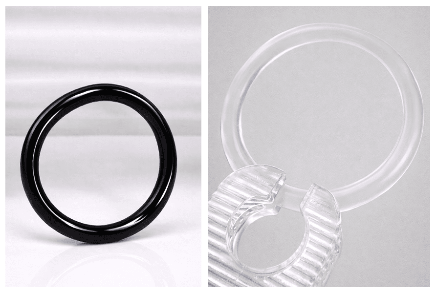 Elastyczny czarny o-ring do plugów, tuneli i rozpychaczy, zaprezentowany solo na białym tle oraz w zbliżeniu z transparentnym wariantem