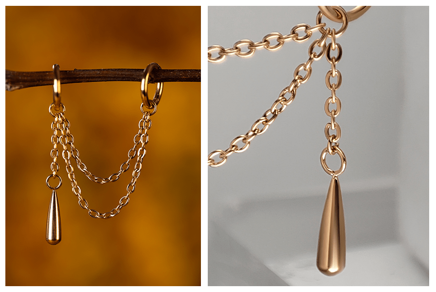 Delikatny łańcuszek do kolczyków z jednostronną łezką, zawieszony między dwoma kółkami i pokazany w zbliżeniu