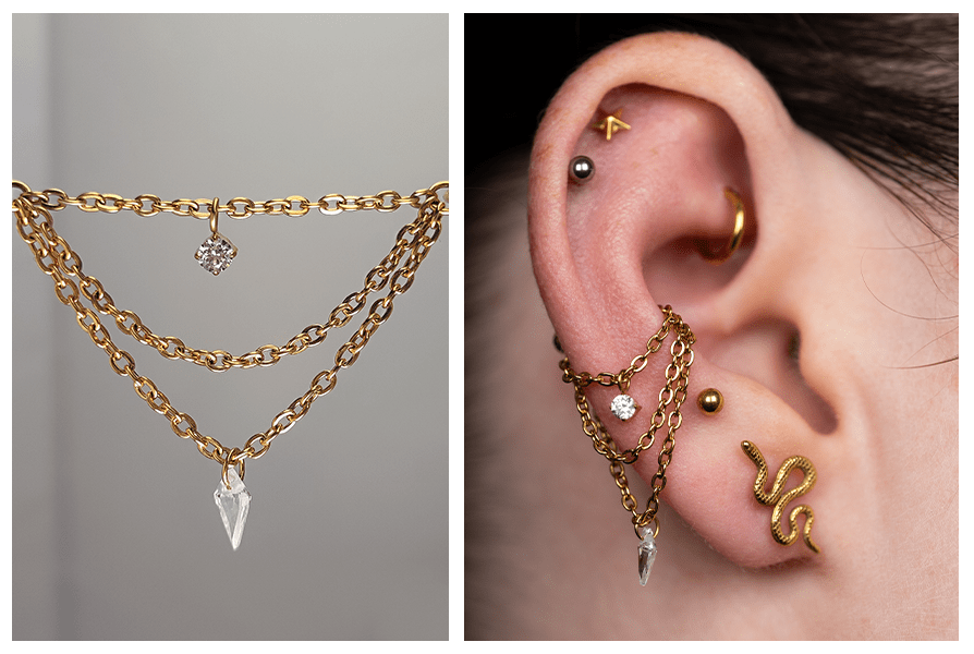 Złoty potrójny łańcuszek do kolczyków z dwoma kryształkami – okrągłym i podłużnym, zawieszony między kółkami oraz pokazany na uchu z kilkoma kolczykami
