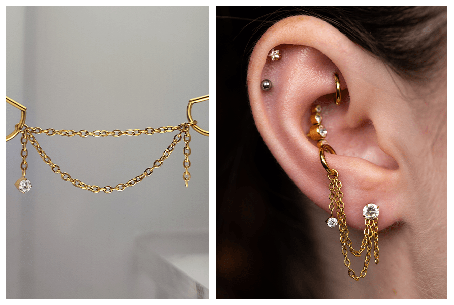 Złoty łańcuszek do kolczyków z dwoma rzędami ogniw i wiszącym kryształkiem, pokazany też na uchu z kilkoma innymi kolczykami