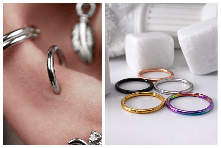 Zbliżenie na srebrne kółko clicker założone w uchu, a obok leży pięć stalowych kółek w różnych kolorach na białym tle