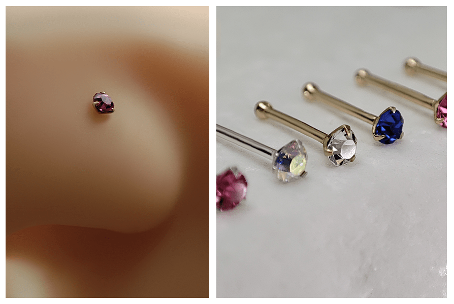 Prosty kolczyk do nosa z różowym kryształem w oprawie na modelu oraz rząd kolczyków z kolorowymi kryształami ułożonych na białym kamieniu