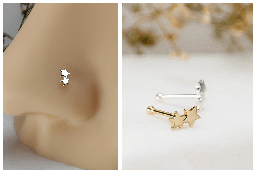 Srebrny prosty kolczyk do nosa z dwiema gwiazdkami założony w nosie oraz komplet złotego i srebrnego kolczyka z gwiazdkami na jasnym kamieniu