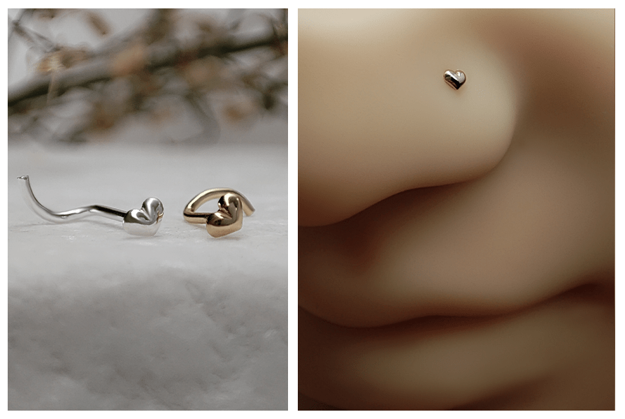 Zakręcony kolczyk do nosa z małym serduszkiem w kolorze srebrnym i złotym na marmurowym tle oraz zbliżenie złotego serduszka w skrzydełku nosa