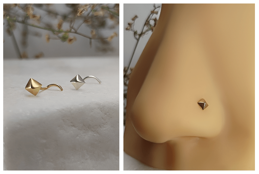 Zakręcony kolczyk do nosa z małym ćwiekiem w kolorze złotym i srebrnym na marmurowym tle oraz zbliżenie na ozdobę w skrzydełku nosa