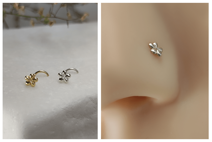 Zakręcony kolczyk do nosa w kształcie kwiatuszka w kolorze złotym i srebrnym na marmurowym tle oraz zbliżenie srebrnego kwiatuszka w skrzydełku nosa