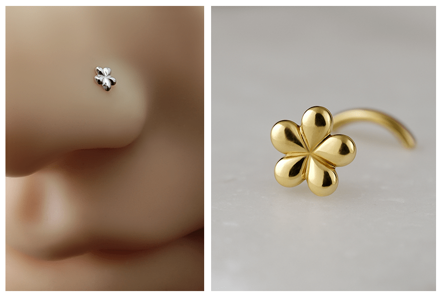 Delikatny zakręcony kolczyk do nosa srebrny kwiatuszek założony w nosie manekina oraz detal złotego kolczyka w kształcie kwiatu na jasnym kamieniu