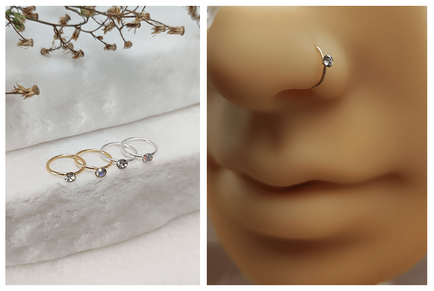 Rozginane kółko do nosa z małym kryształkiem w złocie i srebrze, ujęcie na kamiennym tle i w silikonowym płatku nosa