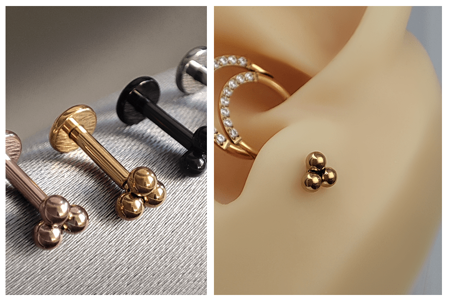 Labrety z trzema kuleczkami ułożone w szeregu (różowe złoto, złoto, czerń, srebro); obok ucho z subtelnie założoną złotą wersją