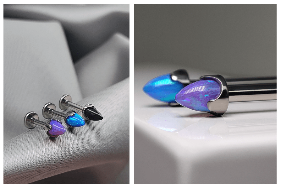 Labrety z opalowym stożkiem bullet na tkaninie – kolory niebieski i fioletowy; makro ujęcie ozdoby