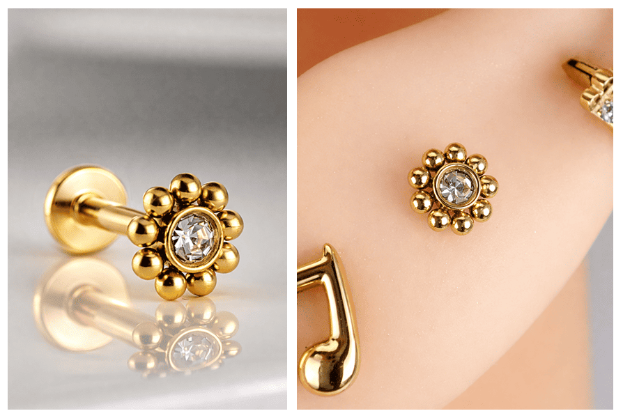 Złoty labret ze stali chirurgicznej 316L z przezroczystym kryształkiem i ozdobnymi kuleczkami, pokazany na jasnym tle oraz założony na uchu