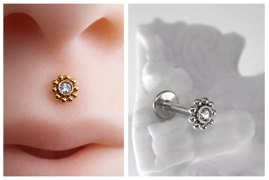 Delikatny labret z przezroczystym kryształkiem otoczonym drobnymi kuleczkami, zaprezentowany w złotej wersji na nosie oraz w srebrnym wariancie na jasnym tle