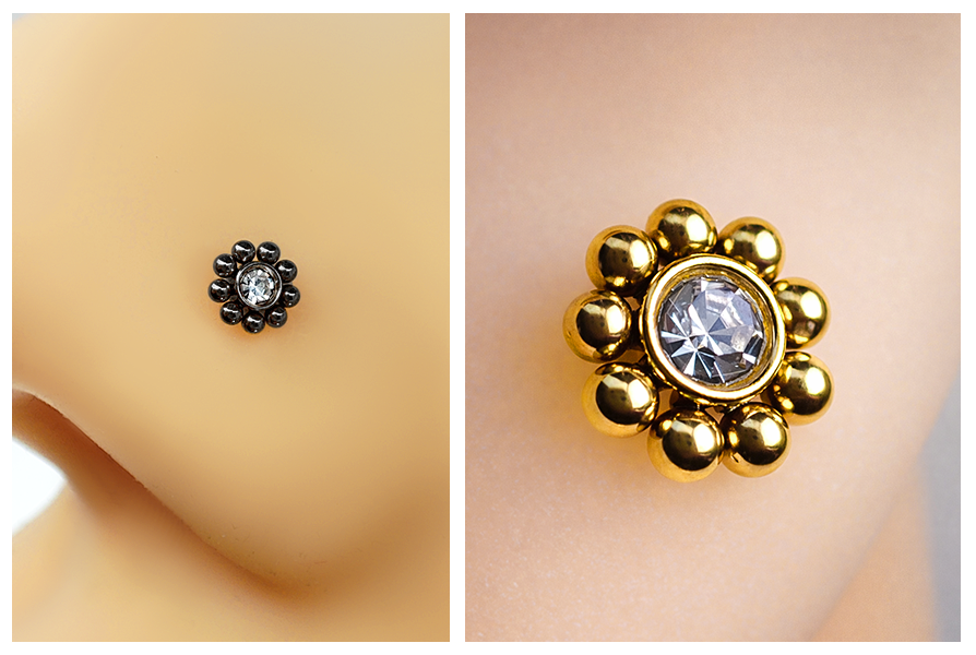 Ozdobny labret ze stali chirurgicznej 316L z przezroczystym kryształkiem i dekoracyjną obwódką z kuleczek, pokazany w czarnej oraz złotej wersji kolorystycznej w dużym zbliżeniu