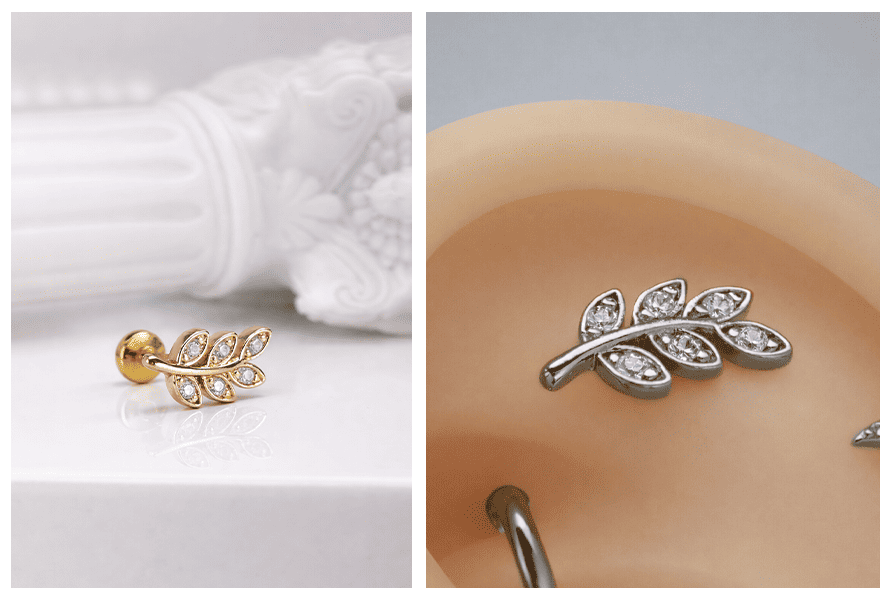 Ozdobny labret z listkiem wysadzanym przezroczystymi kryształkami, pokazany w złotej wersji na jasnym tle oraz w srebrnym wariancie założonym na uchu