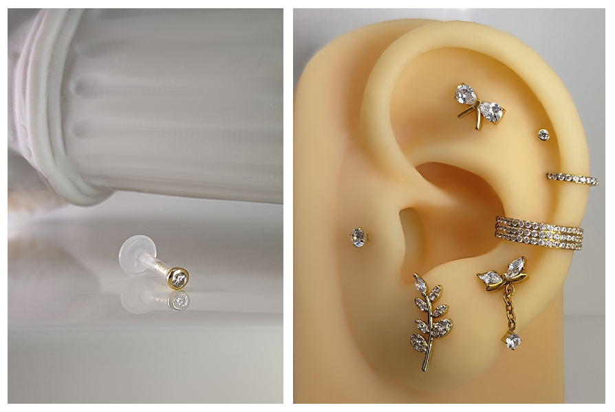 Przezroczysty labret z bioplastu z bezbarwnym kryształkiem w oprawie z 18K złota, pokazany na jasnym tle oraz założony na uchu wśród złotej biżuterii, z zapięciem push in