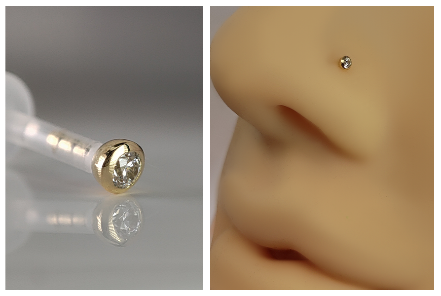 Labret z bioplastu z bezbarwnym kryształkiem w oprawie z 18K złota (zapięcie push in), pokazany w zbliżeniu na jasnym tle oraz założony w silikonowym skrzydełku nosa