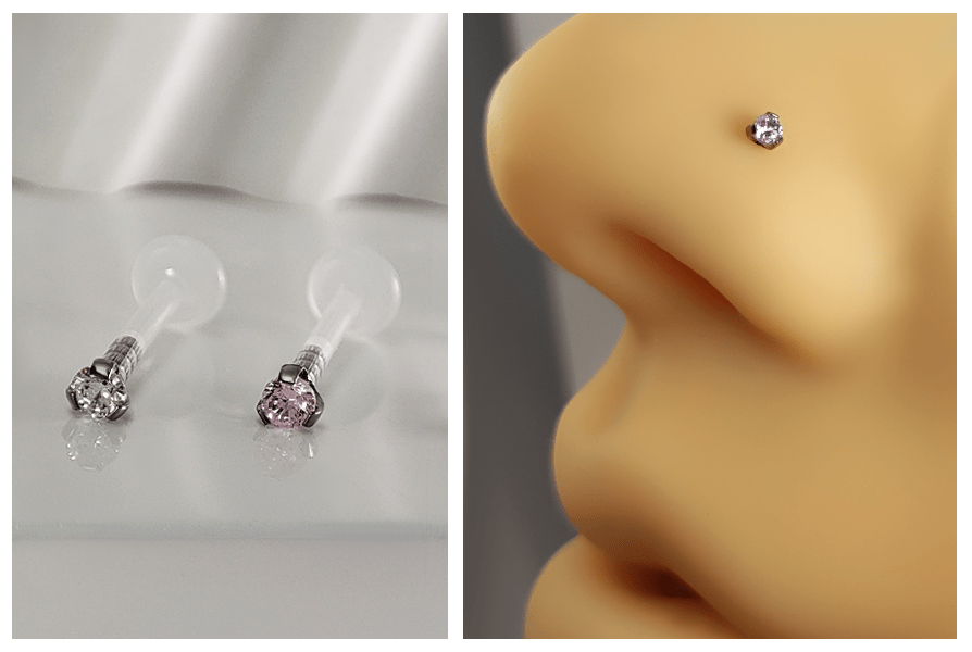 Dwa labrety z kryształami w łapkach na elastycznym pręcie i prezentacja jednego kolczyka w silikonowym nosie