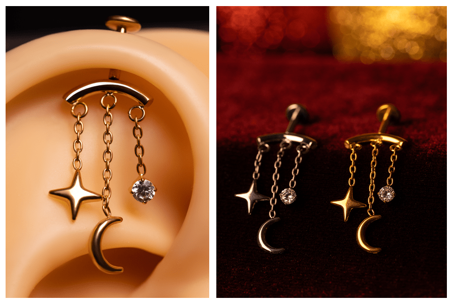 Zbliżenie w uchu: labret do vertical helix z trzema łańcuszkami zakończonymi gwiazdką, księżycem i okrągłym kryształkiem – obok porównanie wersji złotej i srebrnej na czerwonym tle