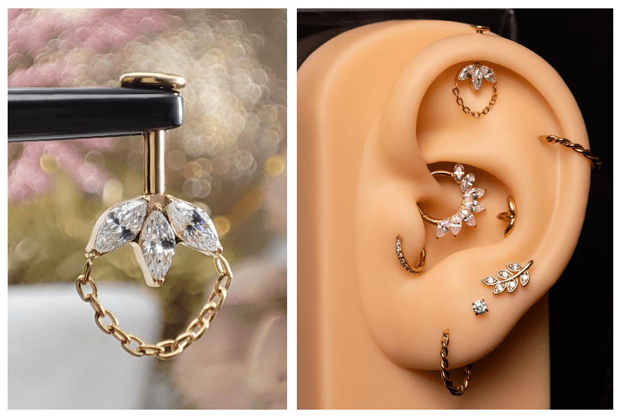 Złoty kolczyk typu labret z trzema przezroczystymi kamieniami w kształcie markizy i pętelką z łańcuszka – pokazany na stojaku oraz założony w górnej części ucha (vertical helix)