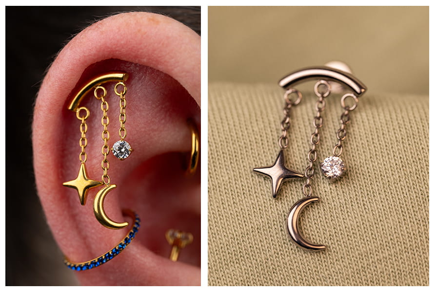 Zbliżenie na złoty labret z wiszącą gwiazdką i księżycem w uchu oraz srebrny wariant kolczyka na jasnym tle