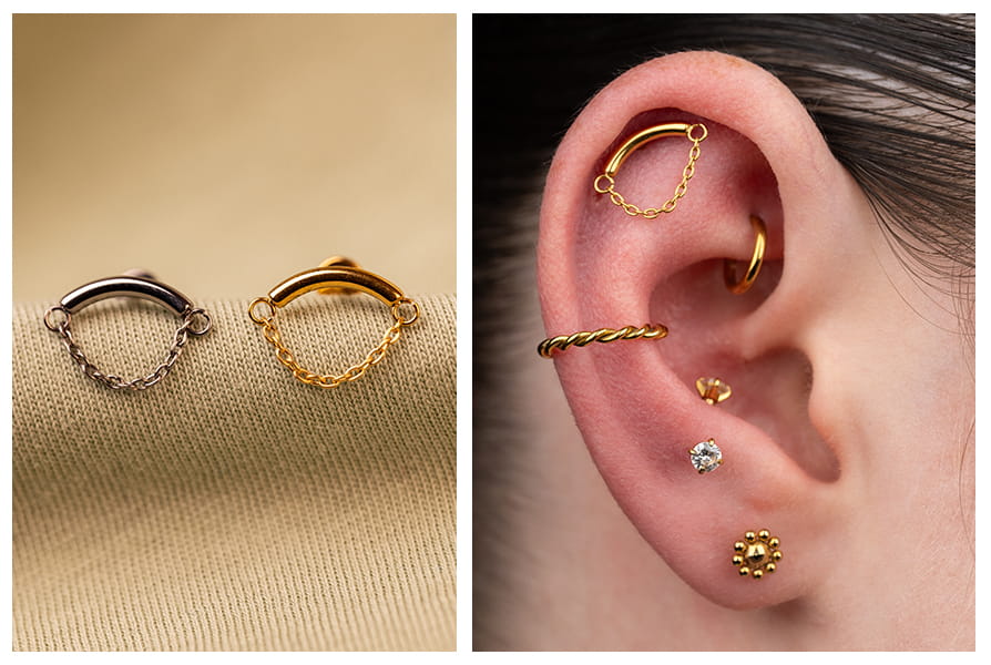 Labret z prostym łańcuszkiem w złotej i ciemnosrebrnej wersji, pokazany na jasnym tle oraz założony w górnej części ucha