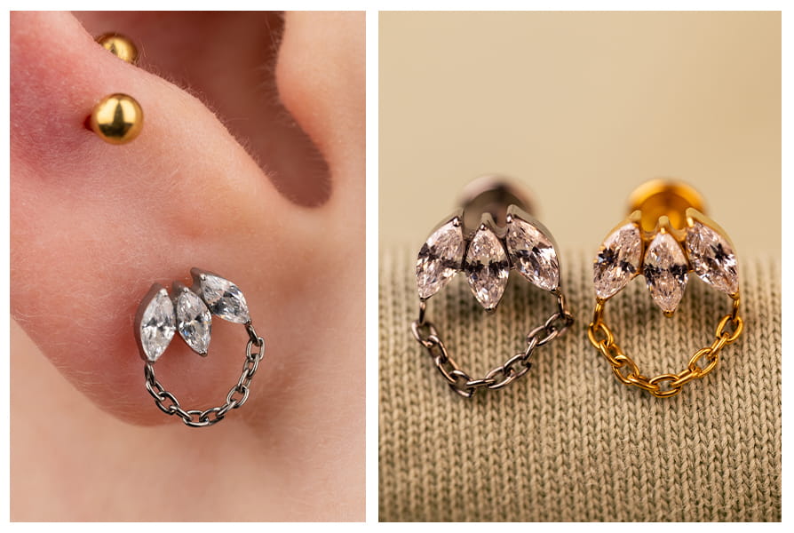 Zbliżenie na labret z łańcuszkiem i markizami, dostępny w srebrnym i złotym wariancie, z delikatnym połyskiem cyrkonii