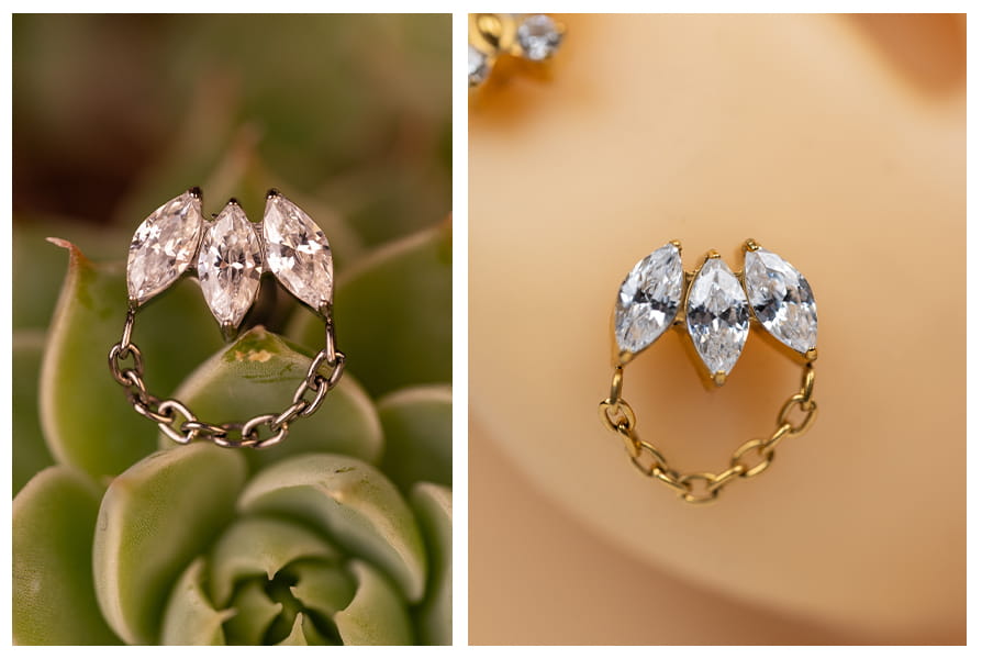 Labret z łańcuszkiem i cyrkoniami w kształcie markizy pokazany na tle sukulenta oraz na modelu ucha w złotej wersji