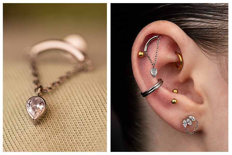 Labret z łańcuszkiem i cyrkonią w kształcie odwróconej łezki w ciemnosrebrnym wykończeniu, pokazany z bliska oraz w stylizacji na uchu