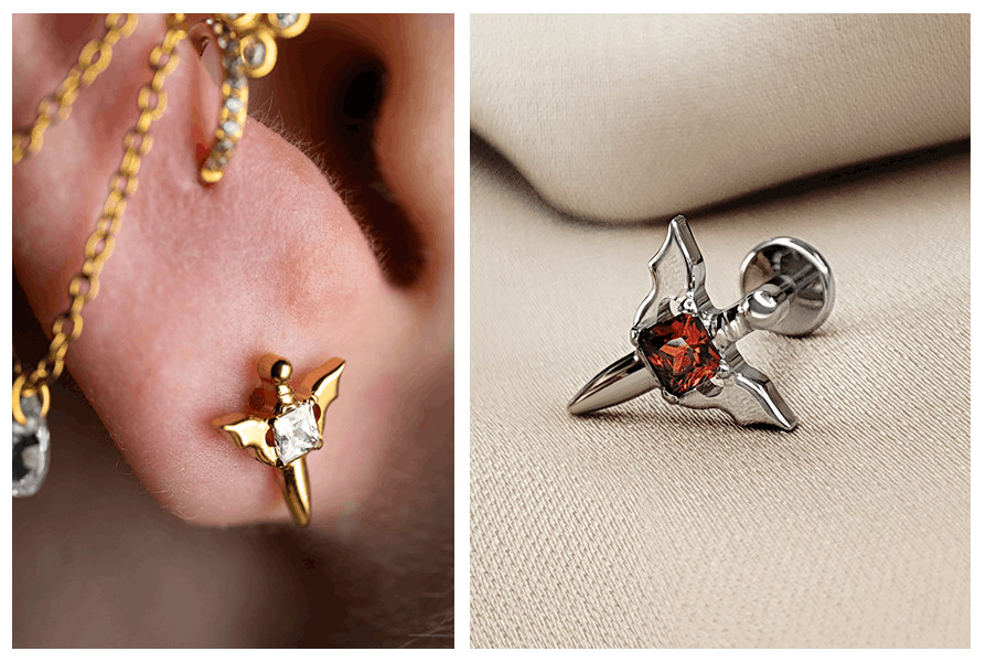 Detal labretu miecz z kryształkiem założonego w uchu (złota wersja z jasnym kamieniem) oraz makro srebrnego miecza z czerwonym kryształkiem na tkaninie